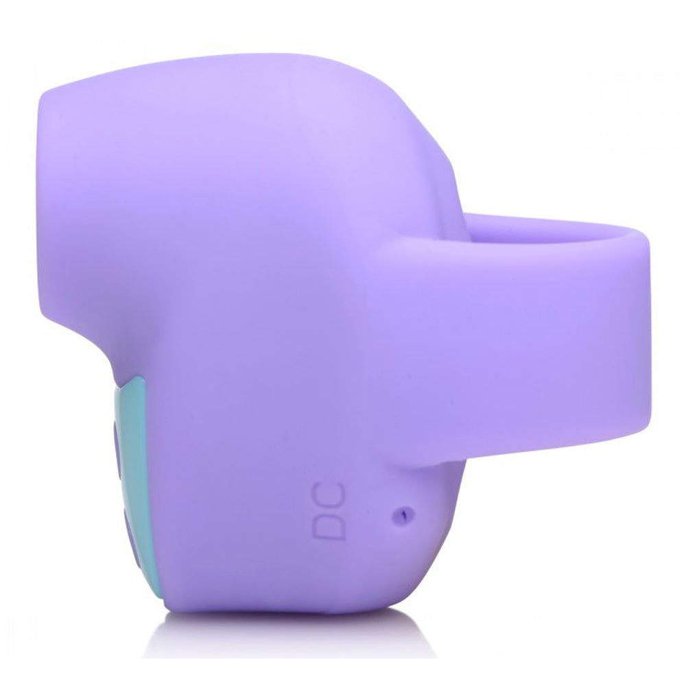 Purple silicone clitoral stimulator with a suction opening and a DC port.
