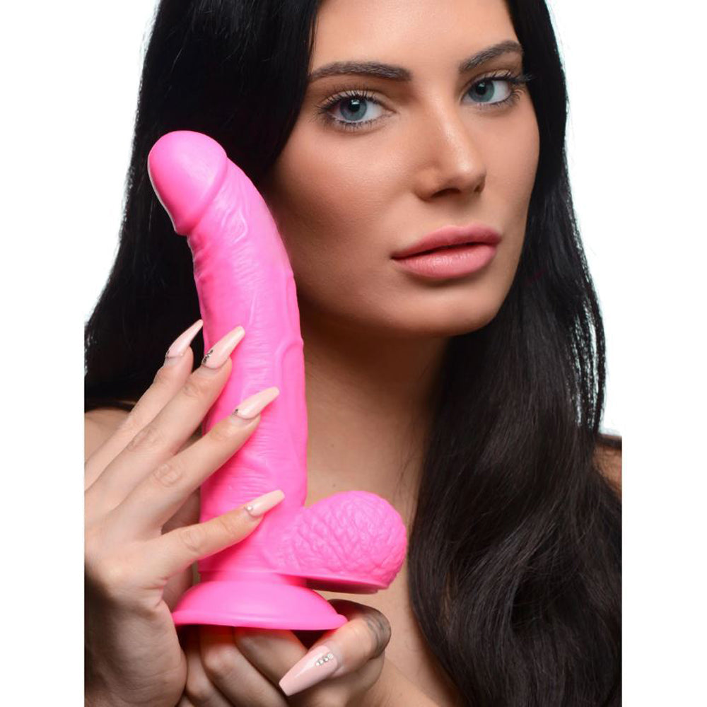 Pink realistic PVC dildo with suction cup base.