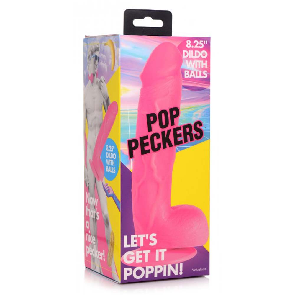 Pink dildo with balls and suction cup on packaging.