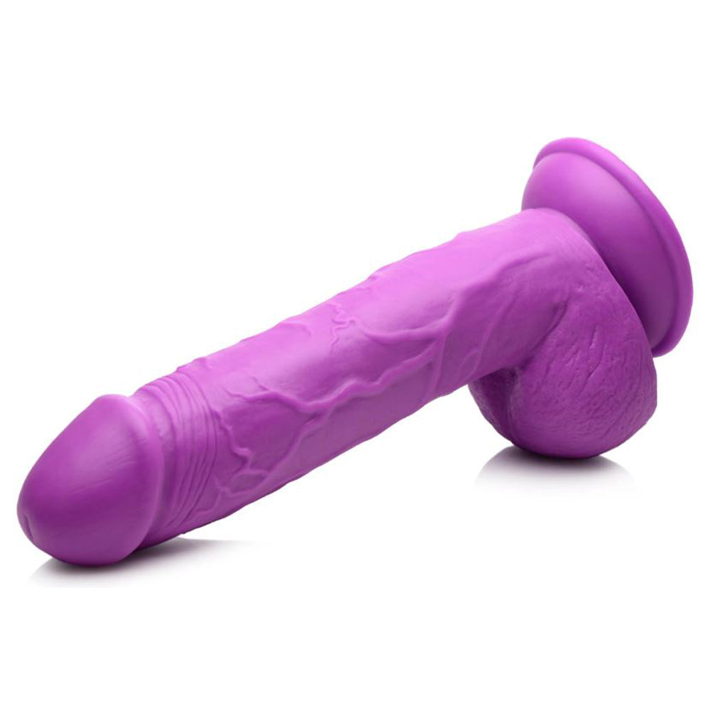 Purple realistic PVC dildo with veined shaft, balls, and suction cup base.