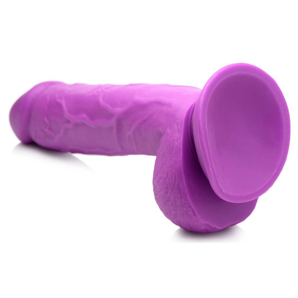Purple realistic PVC dildo with veined shaft, balls, and suction cup base.