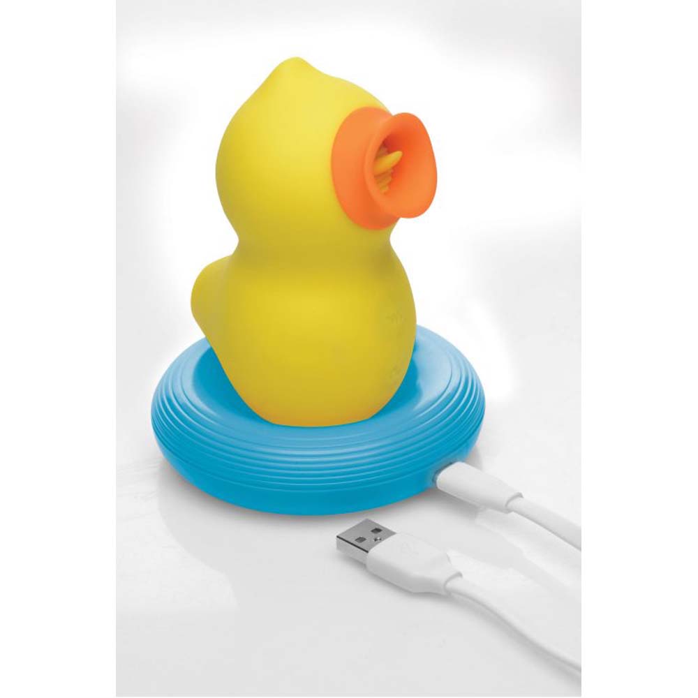 Yellow duck-shaped clitoral suction and licking toy with orange accents on a blue base.