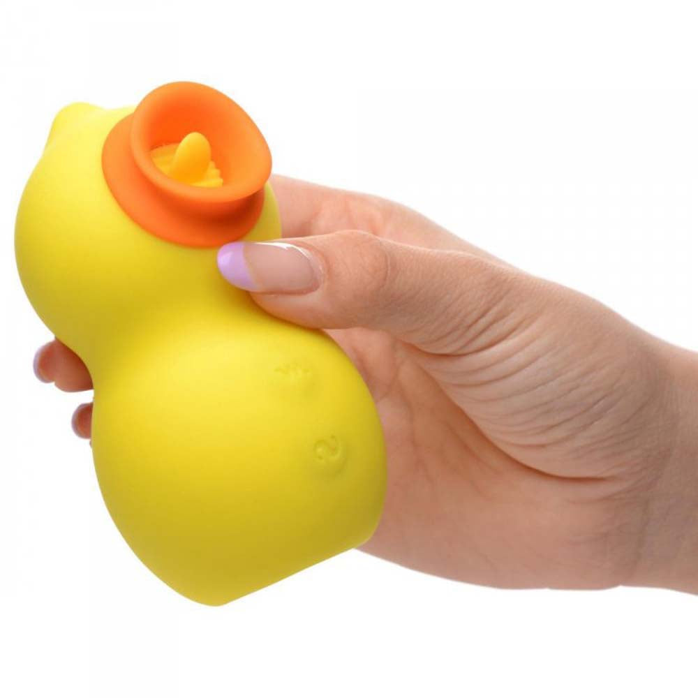 A yellow duck-shaped toy with an orange suction opening held by a hand.