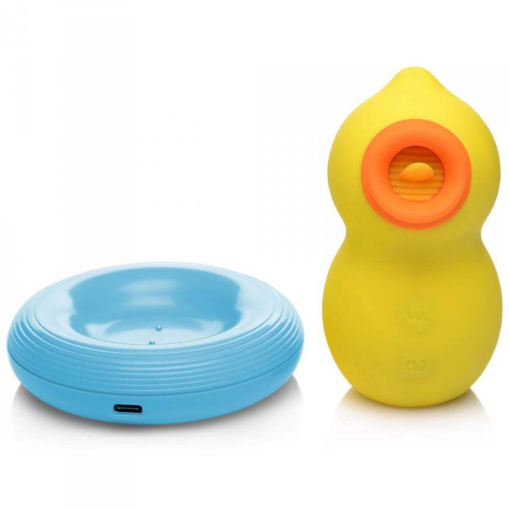 Yellow duck-shaped clitoral suction toy with a blue charging base.