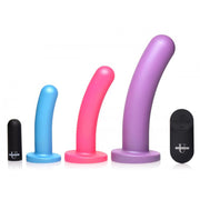 Three silicone dildos in blue, pink, and purple with a black remote.