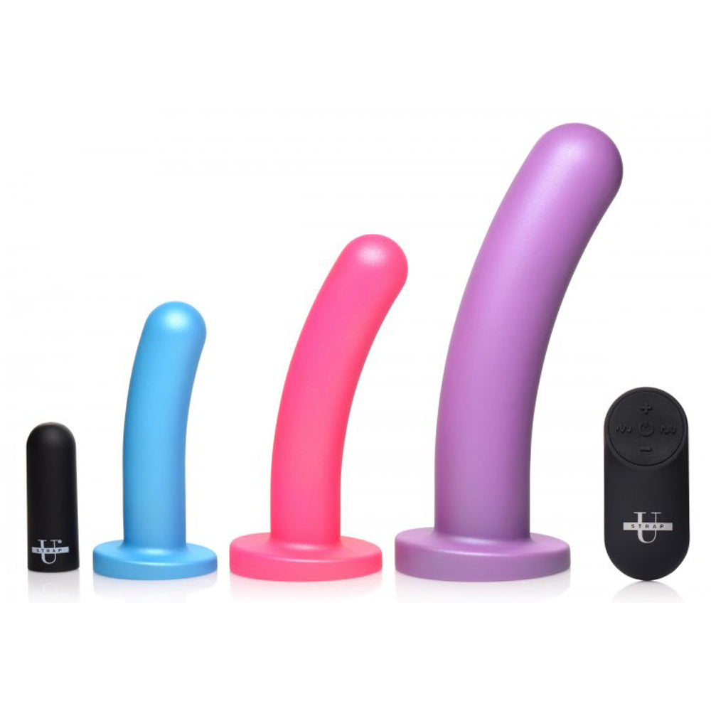 Three silicone dildos in blue, pink, and purple with a black remote.