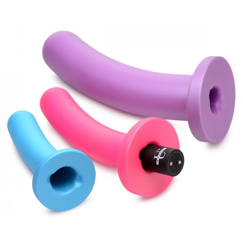 Three silicone dildos in blue, pink, and purple with a remote vibrator.