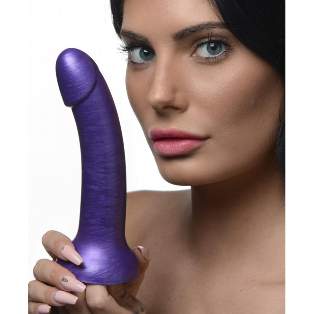 Purple 7-inch metallic silicone dildo with suction cup base, held by a woman.