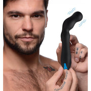 A man holds a black, curved silicone vibrator with a blue accent.