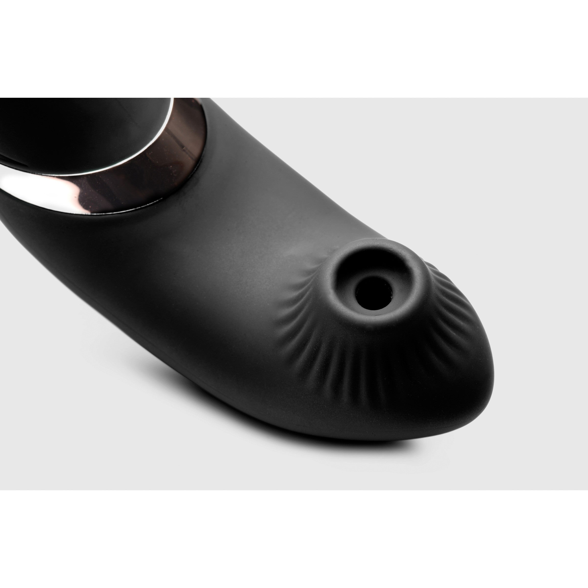 Black silicone vibrator with a textured suction opening and a metallic ring accent.