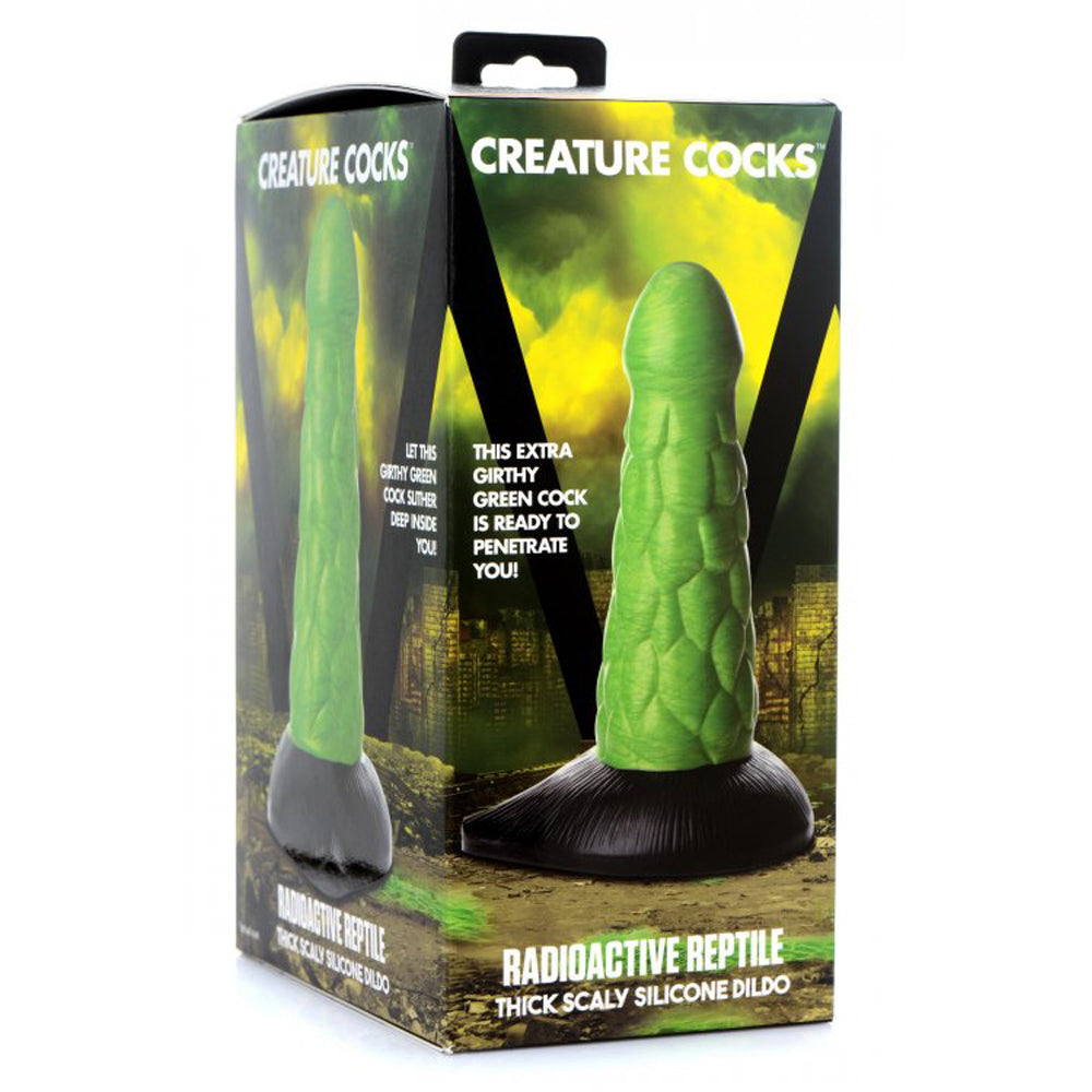 Green scaly silicone dildo with a black suction cup base.