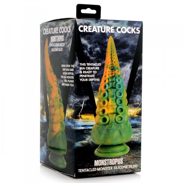 A green and yellow tentacle-shaped silicone dildo with suction cup on a box.