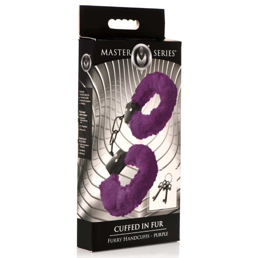 Purple furry handcuffs with metal core and keys on a box.