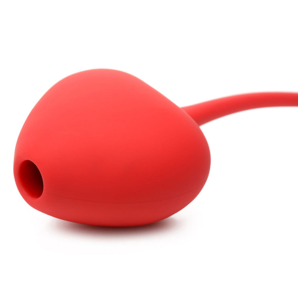 Red silicone clitoral suction stimulator with a vibrating egg.