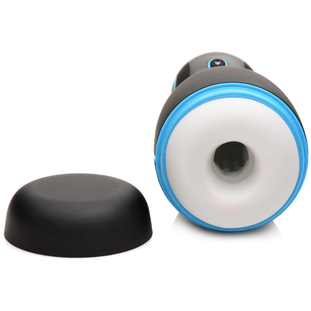 A black and blue vibrating masturbator with a white opening and a black cap.