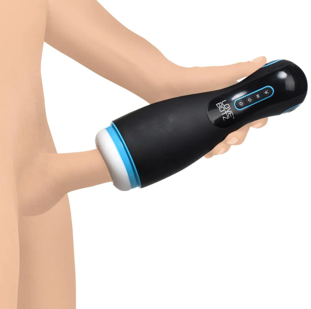 A black and blue vibrating masturbator held by a hand.