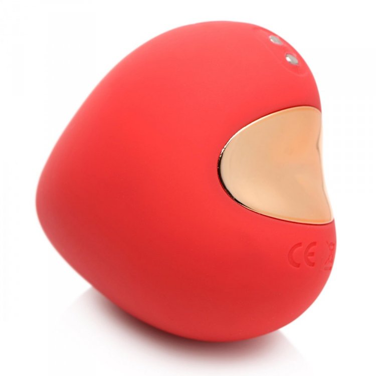 Red silicone clitoral suction toy with gold accent.