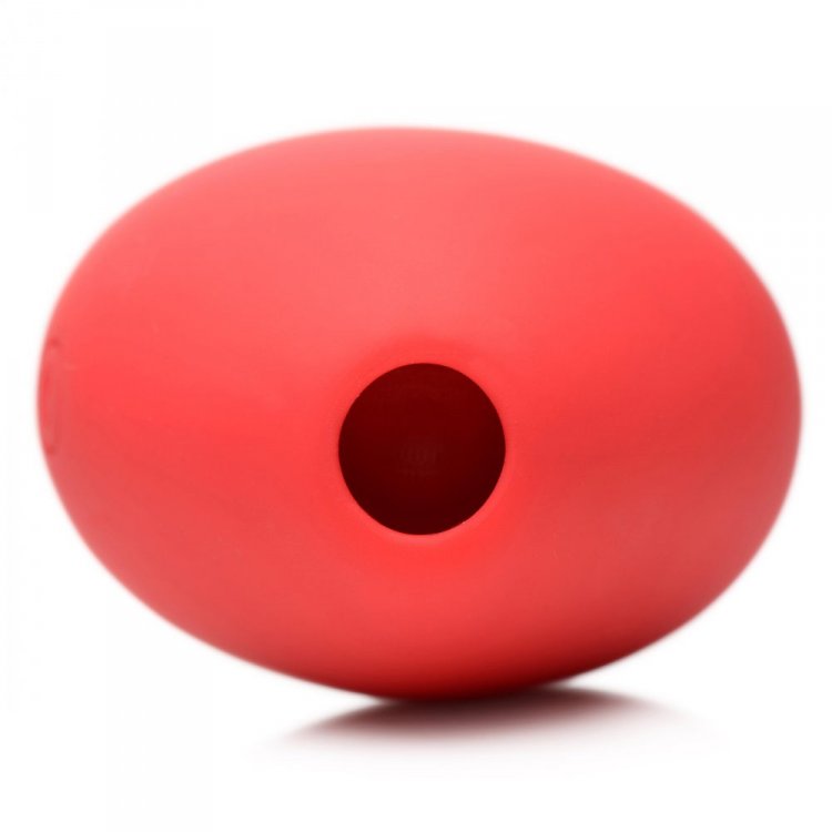 Red silicone clitoral suction toy with a central opening.
