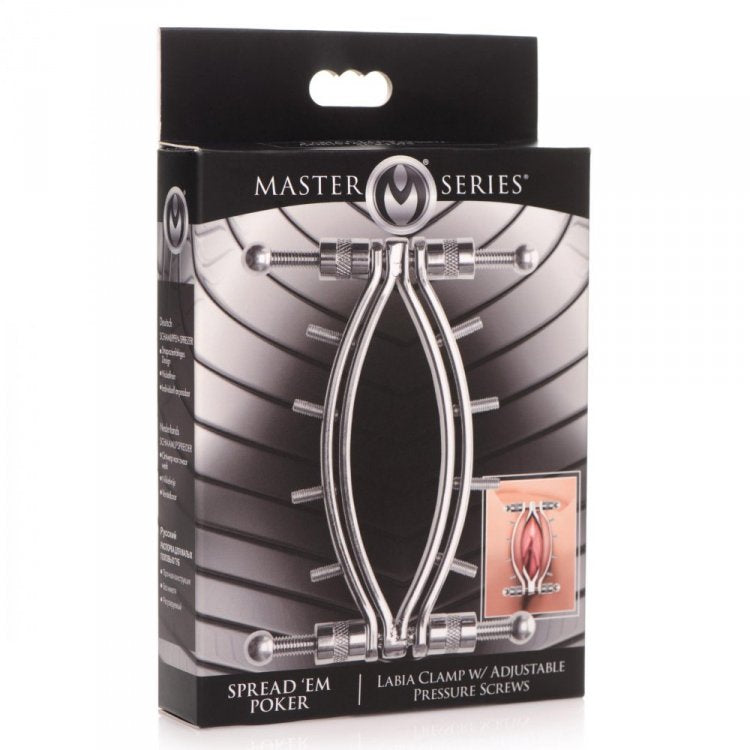 Stainless steel labia clamp with adjustable pressure screws on a black box.