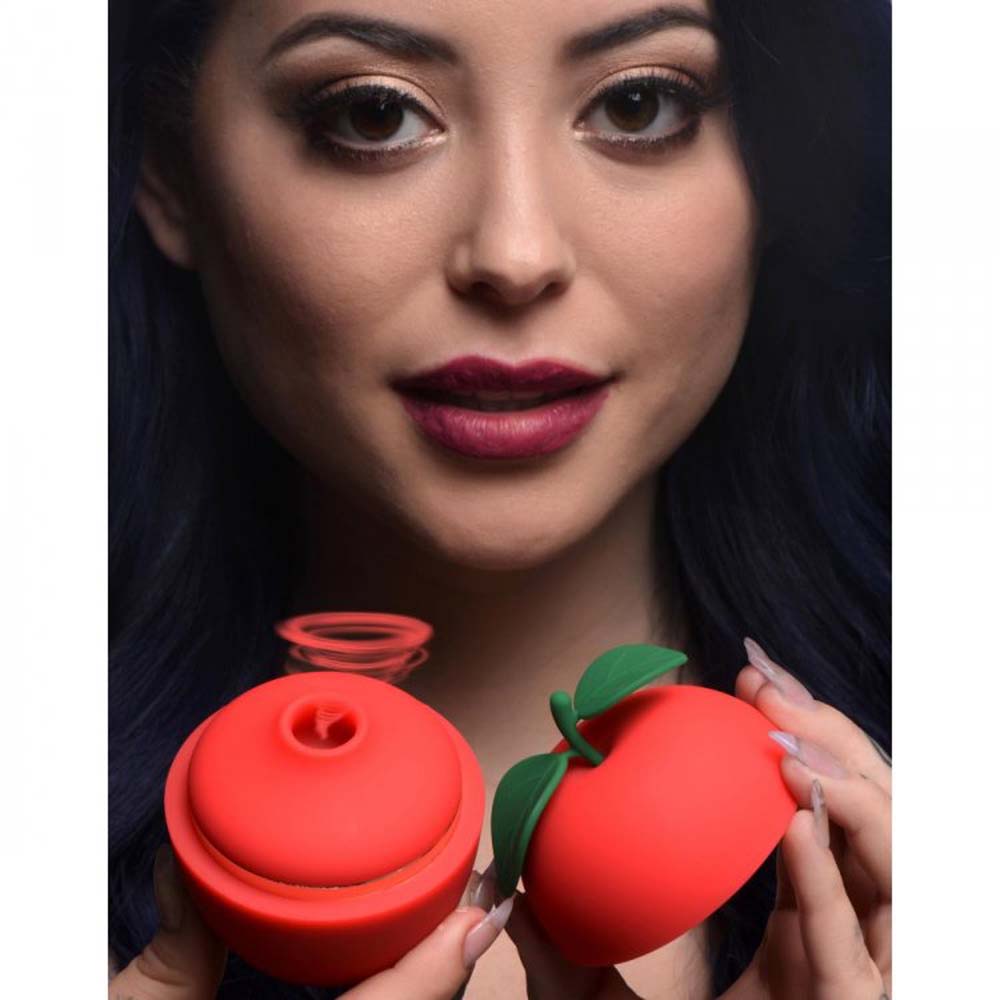Red apple-shaped clitoral stimulator with suction and vibration.