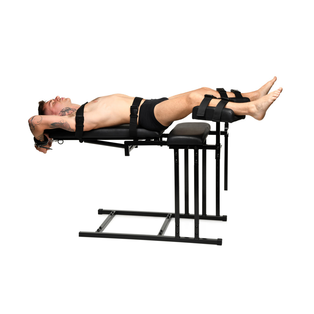 Man secured to an adjustable black bondage chair with a heavy-duty frame.