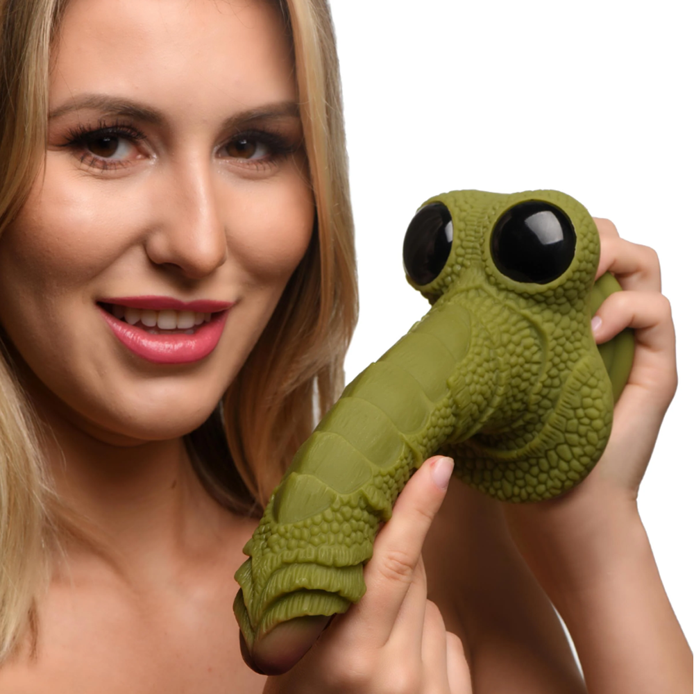 Green scaly fantasy dildo with large black eyes and a textured shaft.