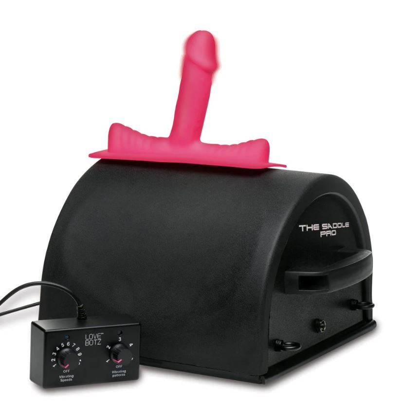 A black Saddle Pro sex machine with a pink attachment and a remote control.