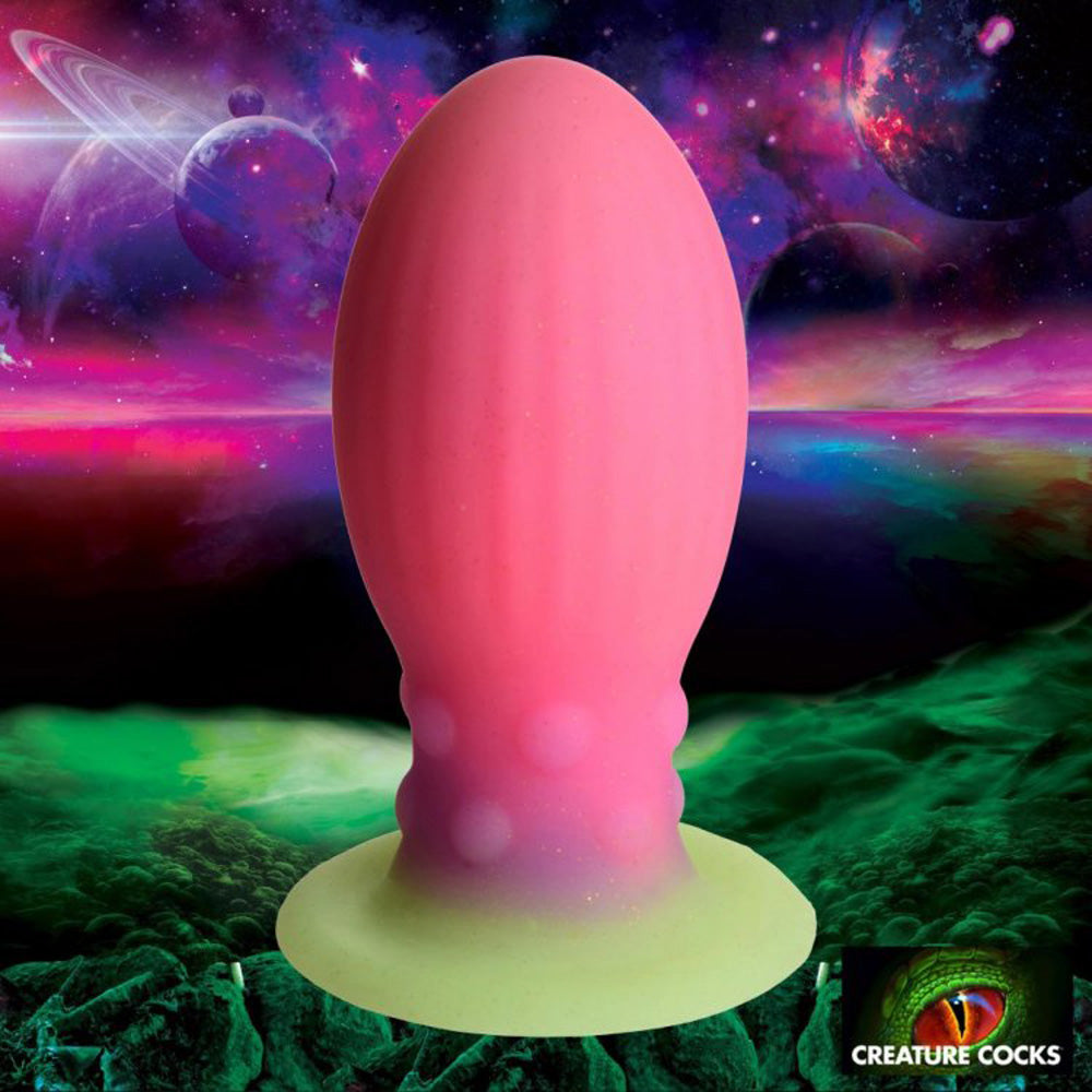 Pink and yellow glow-in-the-dark silicone fantasy toy with textured bumps.