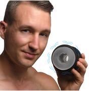 Man holding a black and clear vibrating stroker with blue wavy lines.