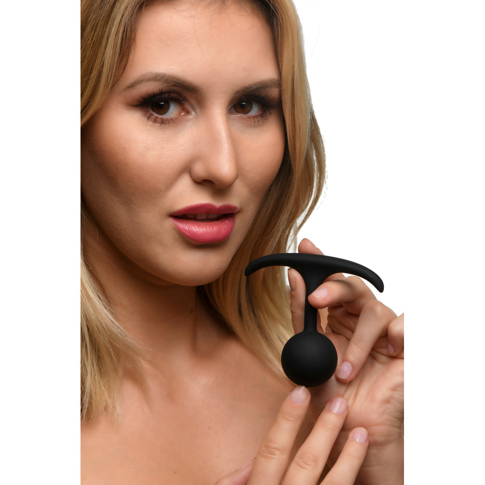 Black weighted silicone anal plug with a T-shaped handle.