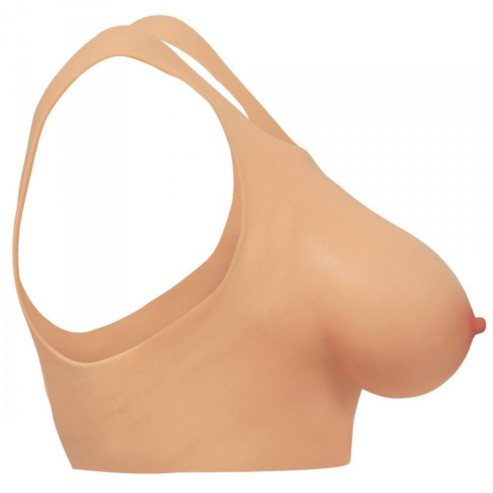 D-cup silicone breast forms with a harness.