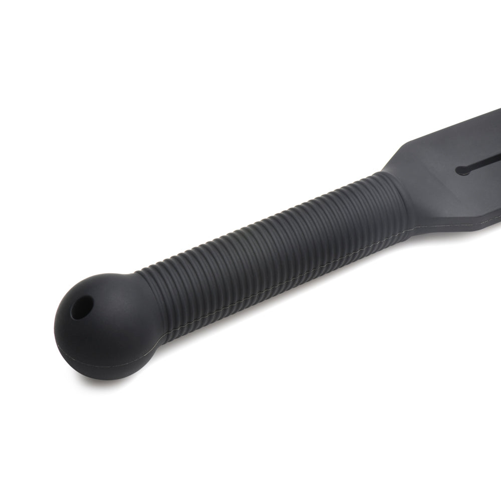Black silicone tawse with a ribbed handle and a rounded end with a hole.