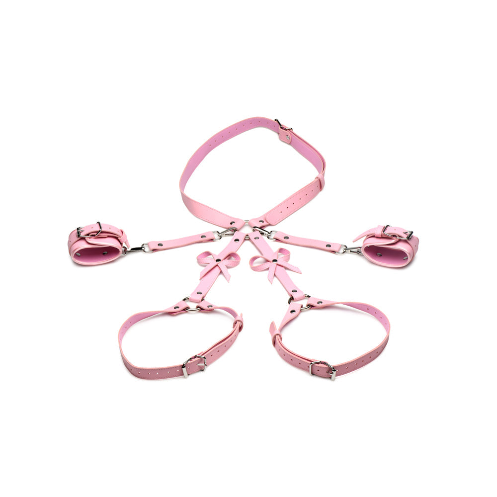 Pink vegan leather bondage harness with wrist cuffs and bows.