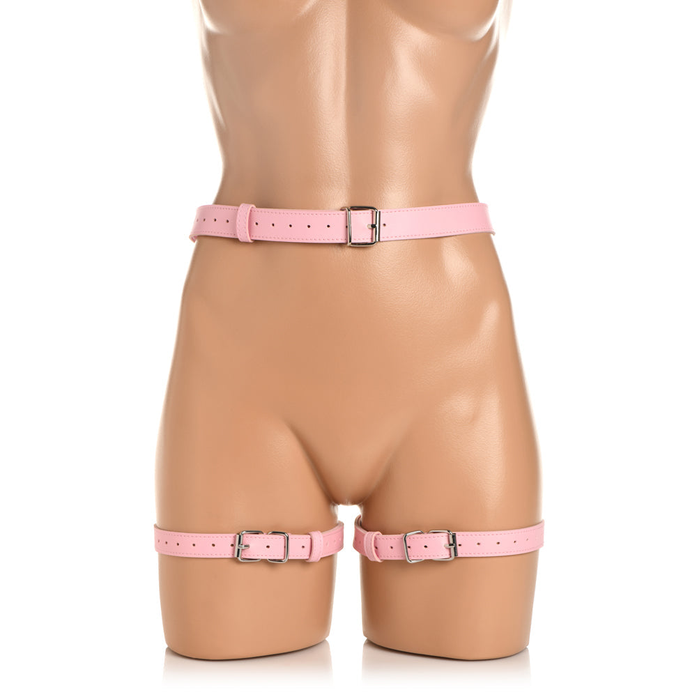 Pink vegan leather harness with adjustable waist and thigh straps.