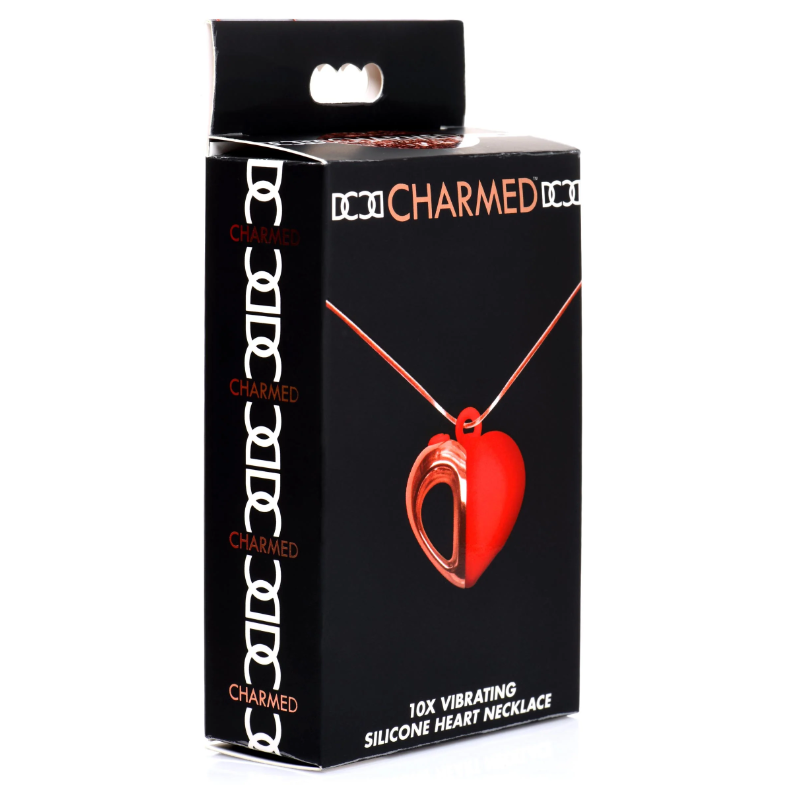 Black box packaging for a red silicone heart necklace with "CHARMED" branding.