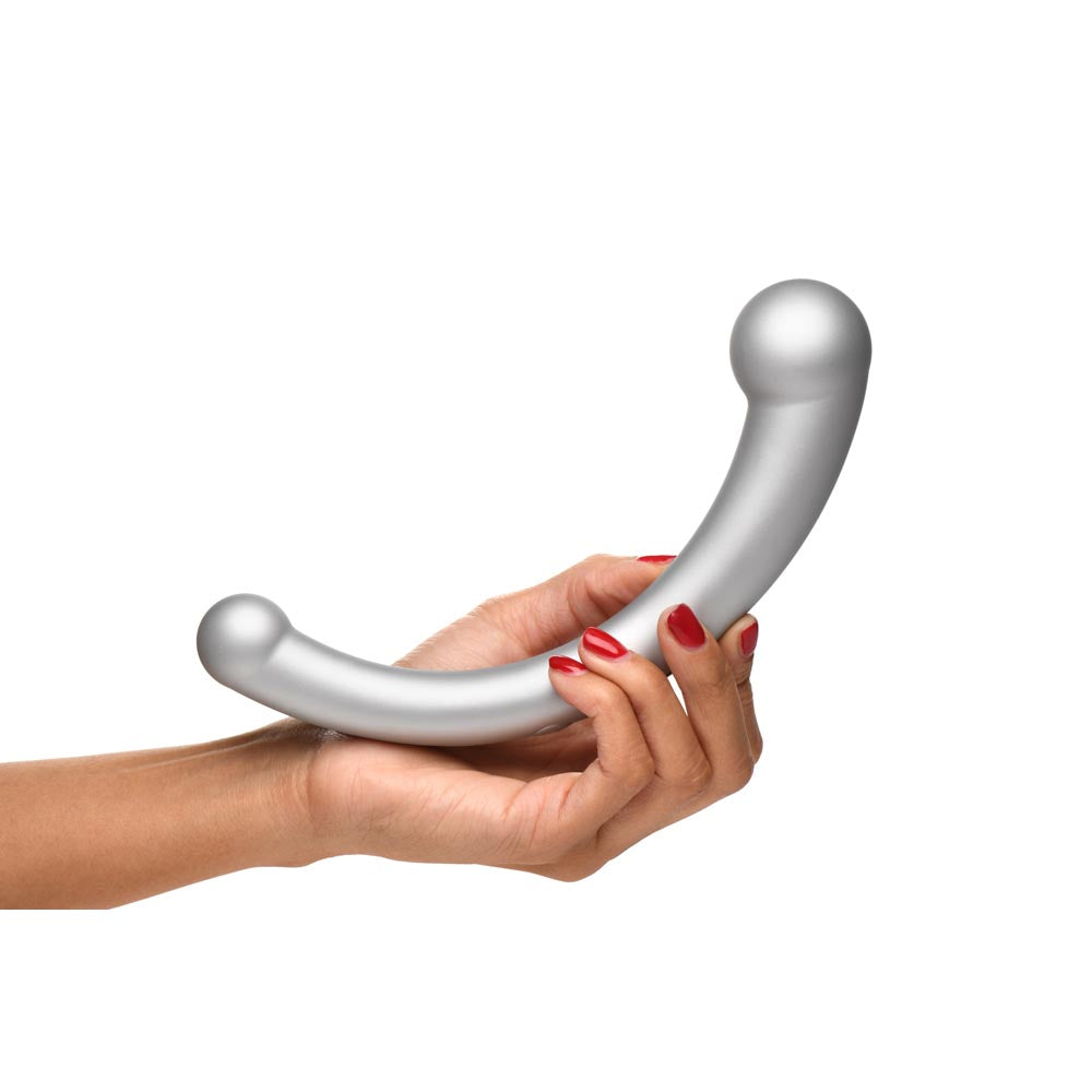 Silver curved vibrator held in a hand with red nail polish.