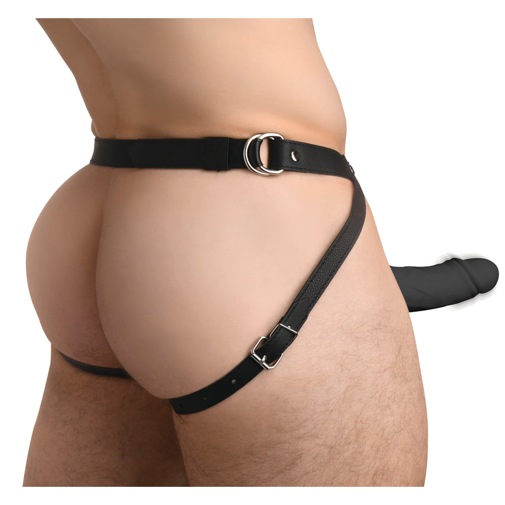 Rear view of man wearing black leather harness with attached black vibrating silicone penis sheath.