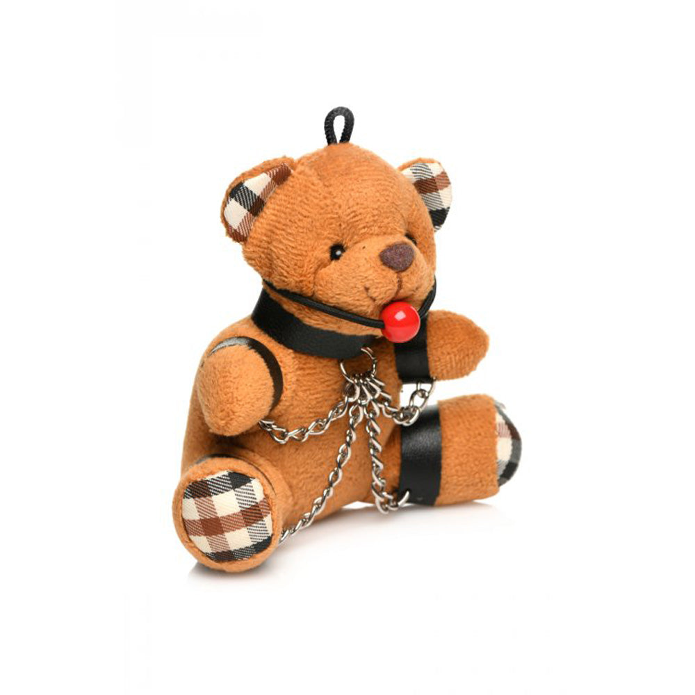 Burnt orange teddy bear keychain with ball gag and chains.