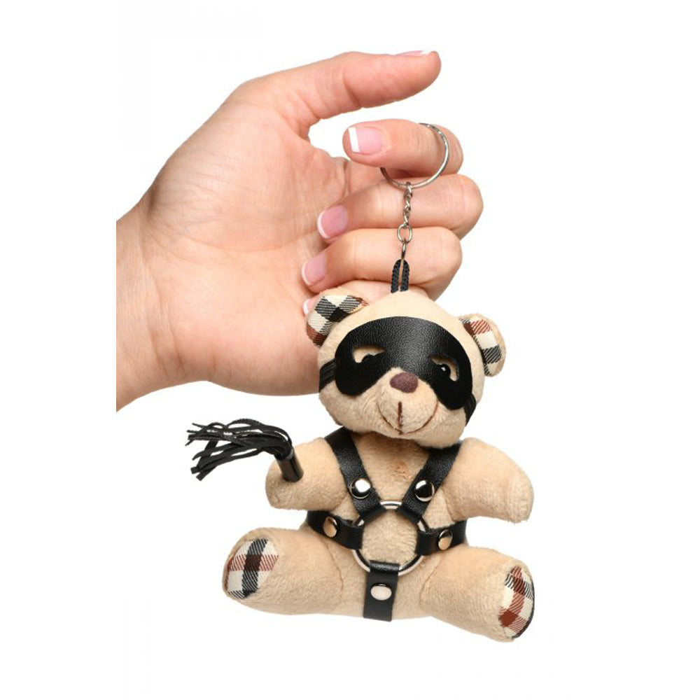 Teddy bear keychain with faux leather harness, mask, and mini flogger.