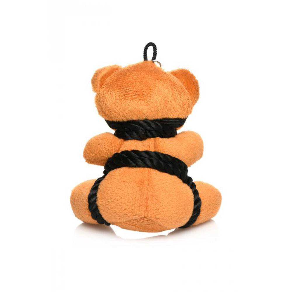Burnt orange teddy bear keychain with black rope accents.