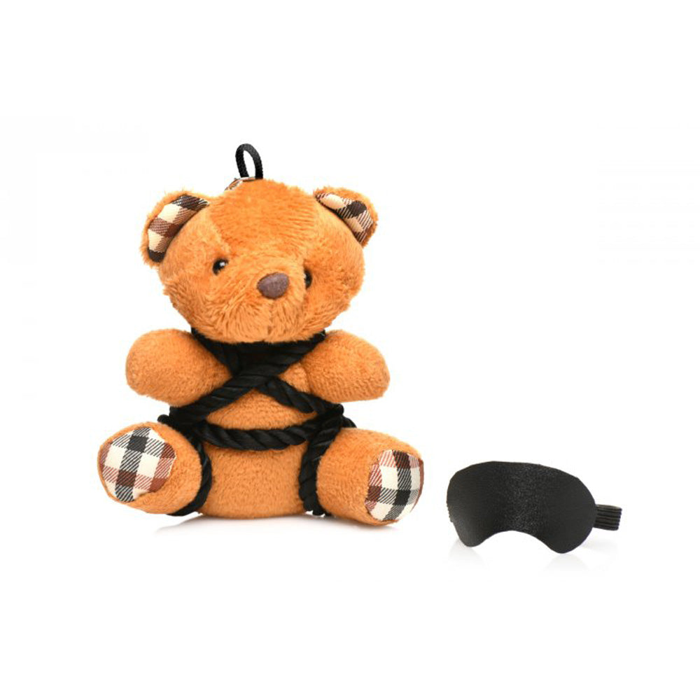 Burnt orange teddy bear keychain with rope and blindfold.