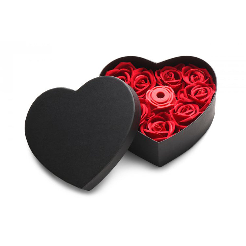 Black heart-shaped gift box with red faux roses and a red silicone rose toy.