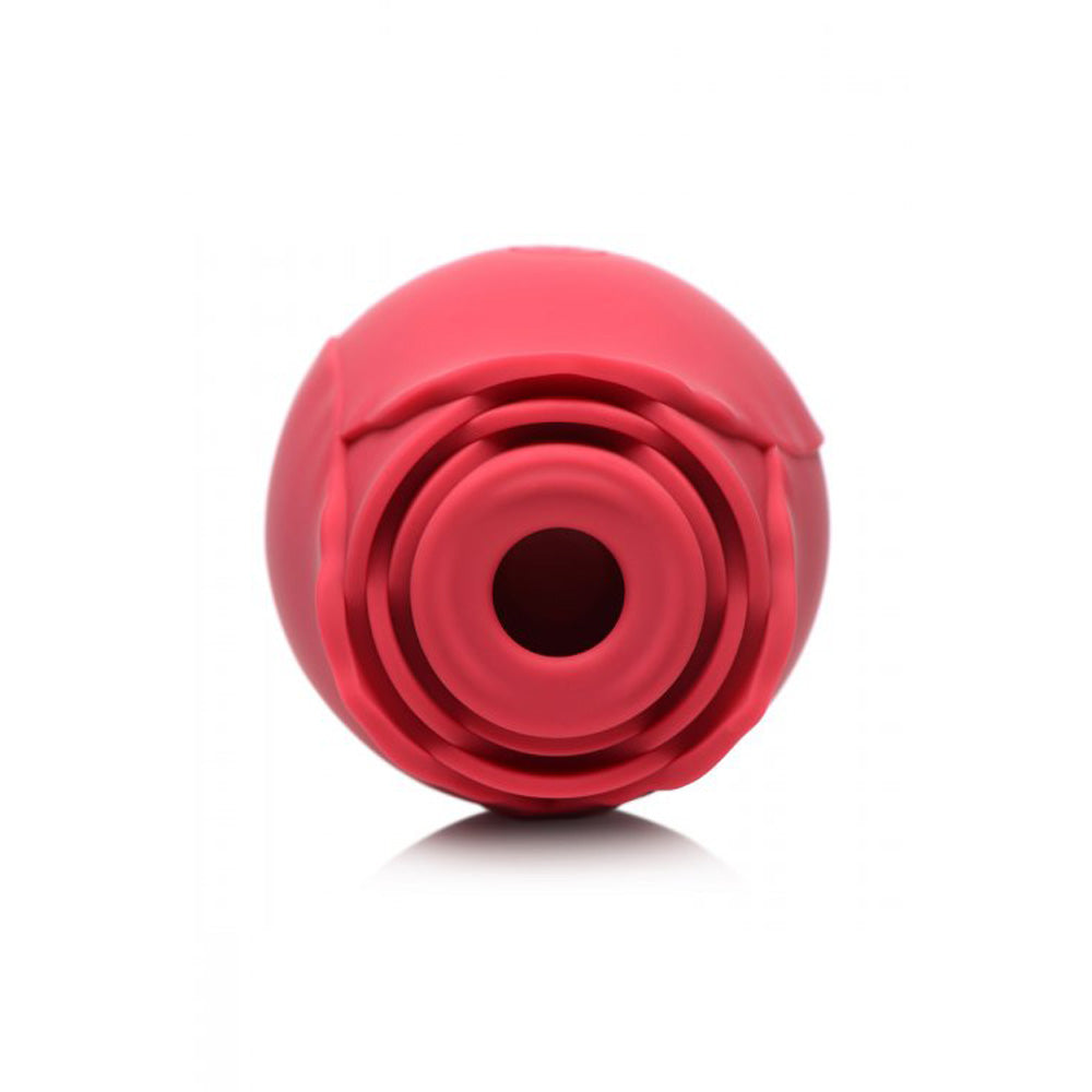 Red silicone rose toy with textured petals and concentric rings.