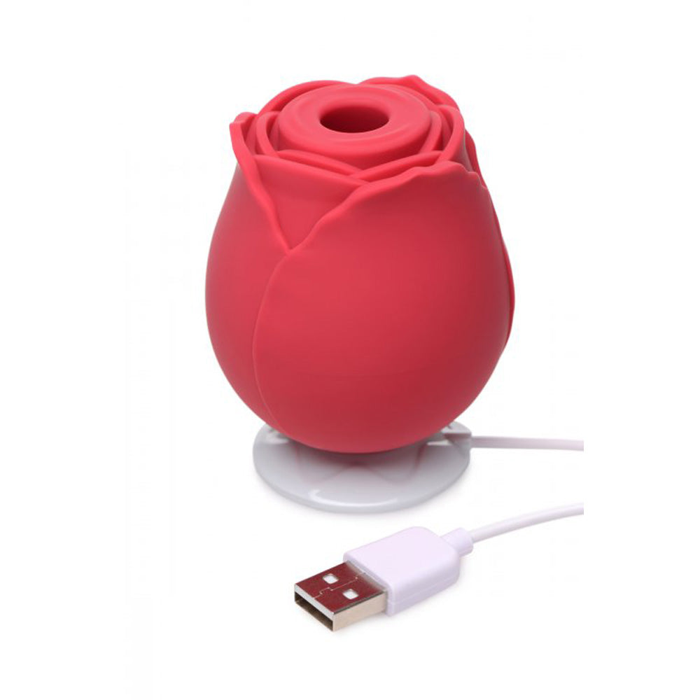 Red silicone rose-shaped toy with a USB cable.