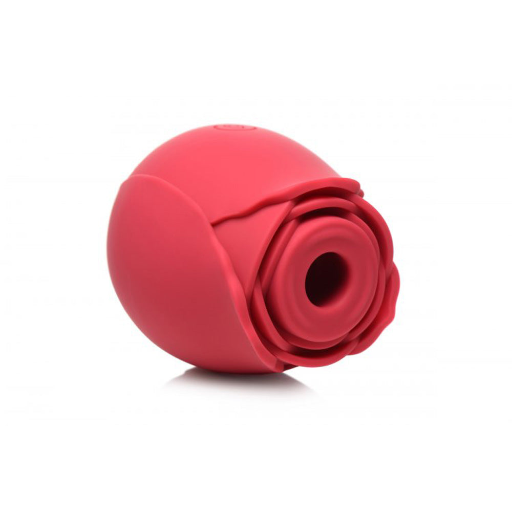 Red silicone rose toy with textured petals and a central opening.