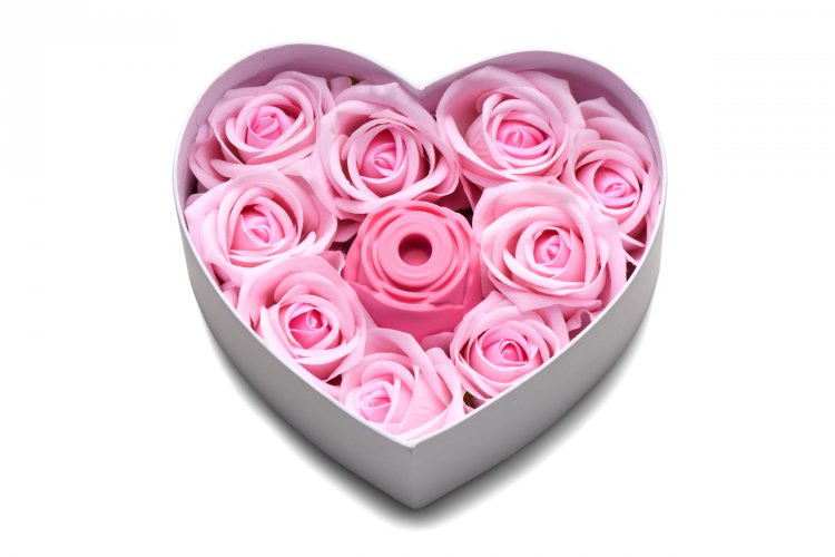 Pink faux roses in a heart-shaped box with a pink rose-shaped silicone toy.