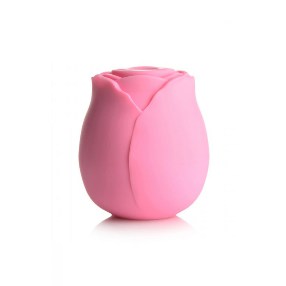 Pink silicone rose toy in a gift box with faux roses.