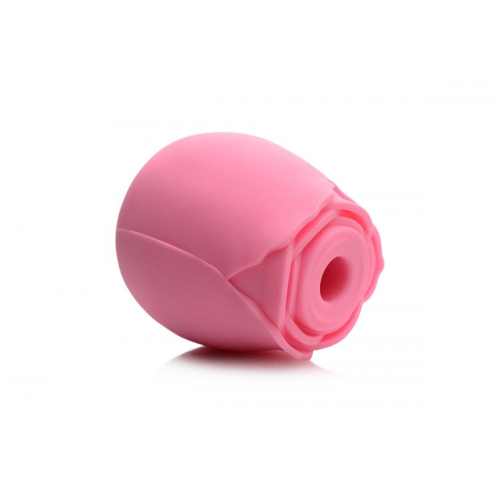 Pink silicone rose toy with faux roses in a gift box.