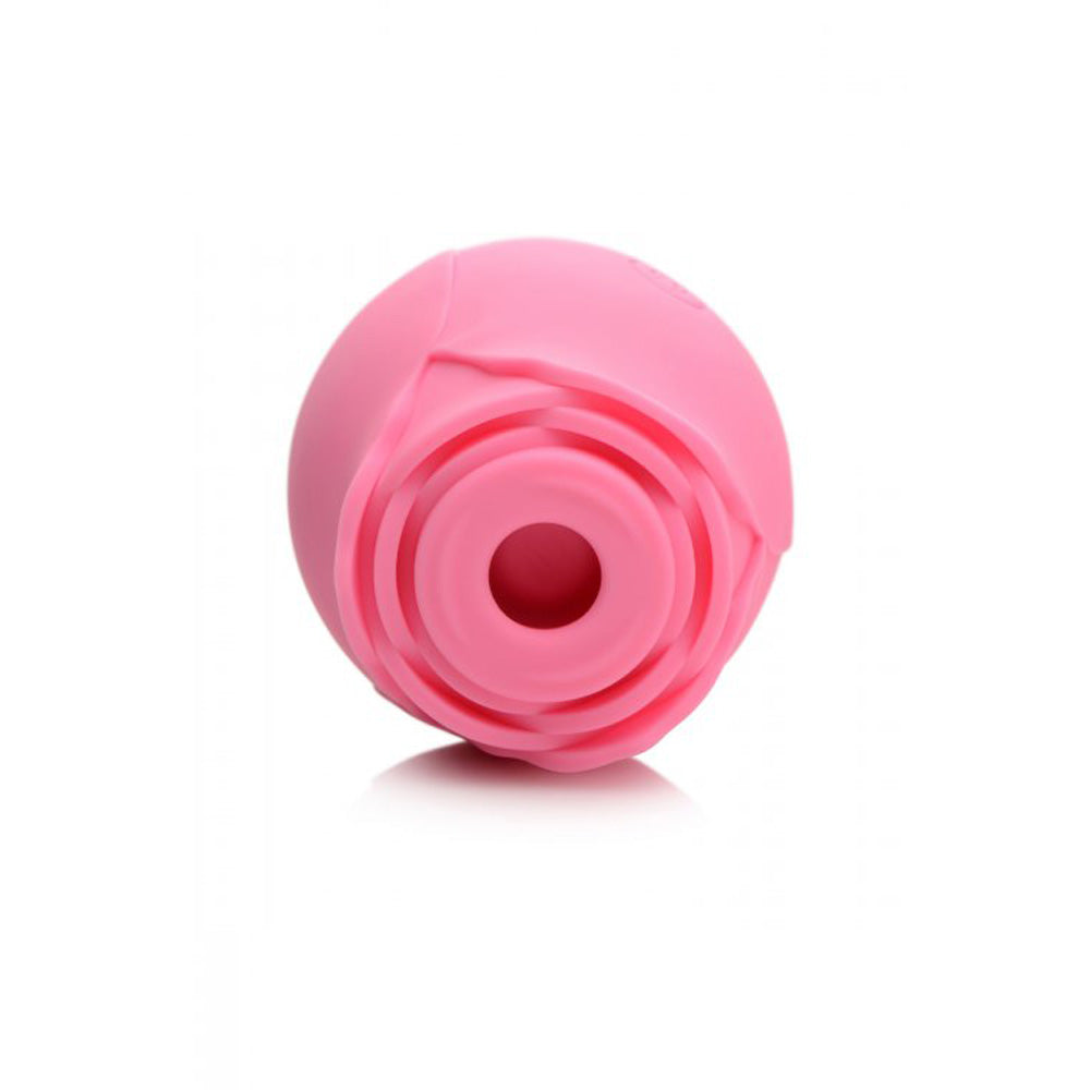 Pink silicone rose toy with textured petals and a central opening.