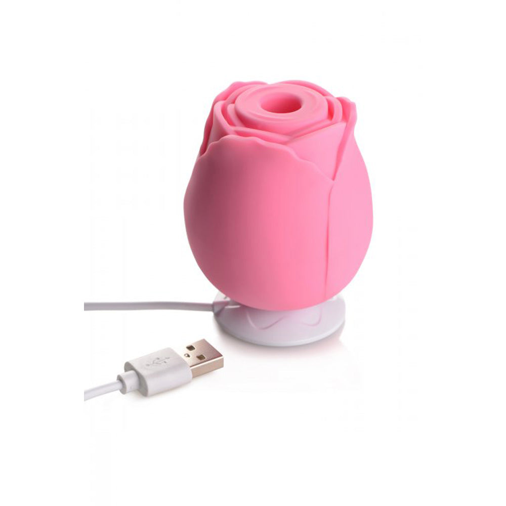Pink silicone rose toy with a USB cable.